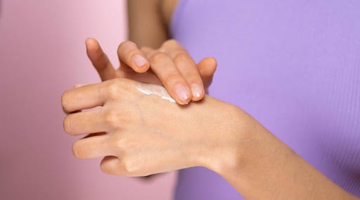 woman applying hydrating CBD hand and body lotion with safflower and shea butter